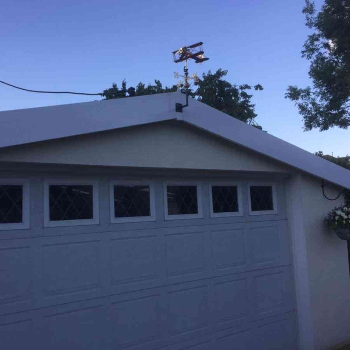 biplane_weathervane_installed_on_a_garage